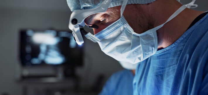 surgery-hospital-doctor-with-face-mask-operation-medical-emergency-service-theater-healthcare-procedure-closeup-surgeon-with-light-patient-injury-wellness-accident